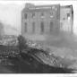Image showing stack demolished, dust still in air & factory in background